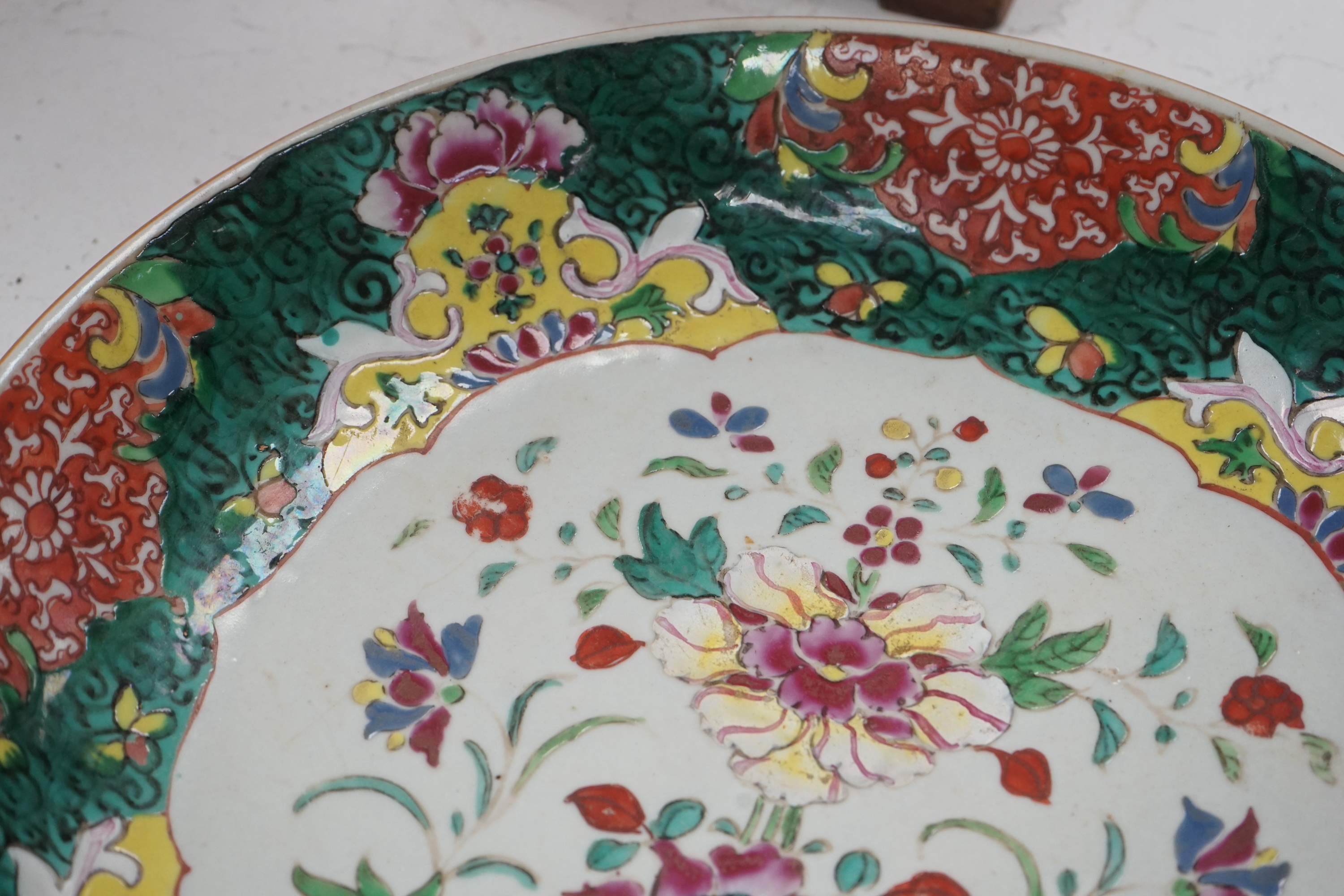 A Chinese straits famille rose dish, 19th century, 33cm diameter. Condition - crack to base